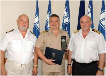Captain Sylla Sergiy (middle) presented with the award at Marlow’s office in Ukraine